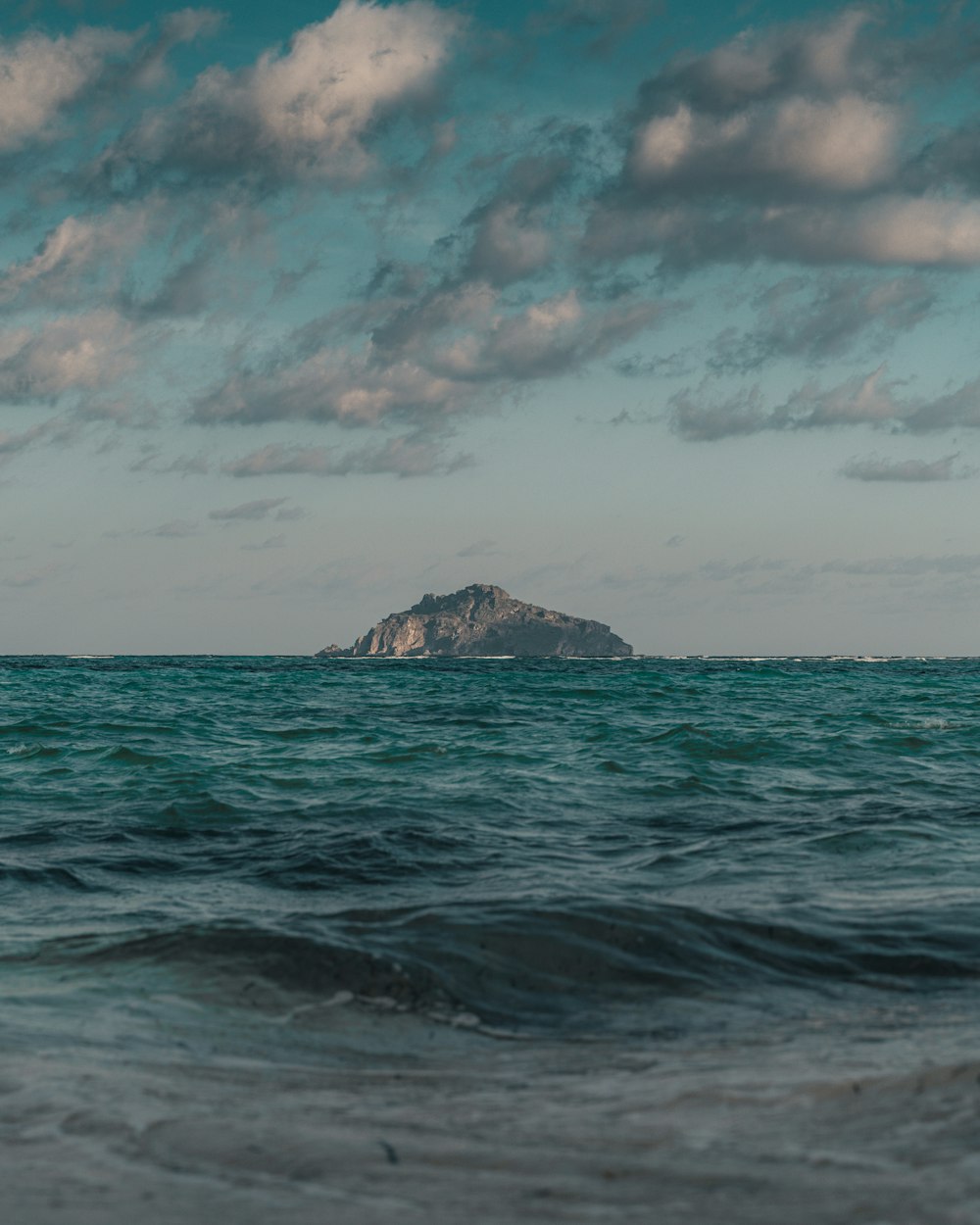 ocean waves crashing on shore during daytime