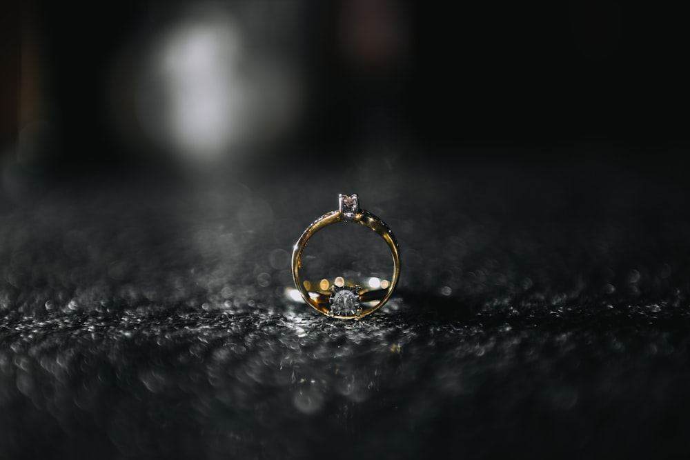 gold ring on black and white surface