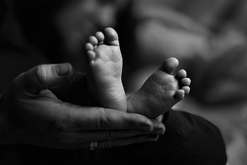 grayscale photo of babys feet