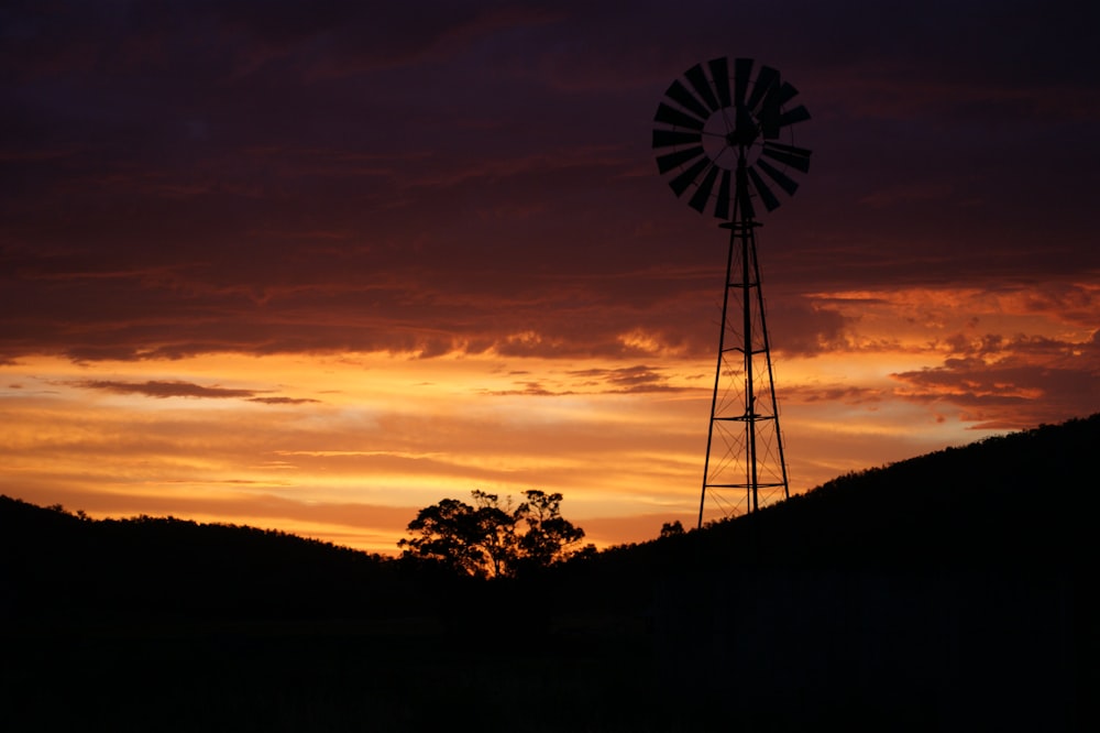 silhouette of windmill during sunset