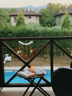Guests enjoying a quiet moment on a balcony overlooking a lush garden.