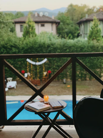 Guests enjoying a quiet moment on a balcony overlooking a lush garden.
