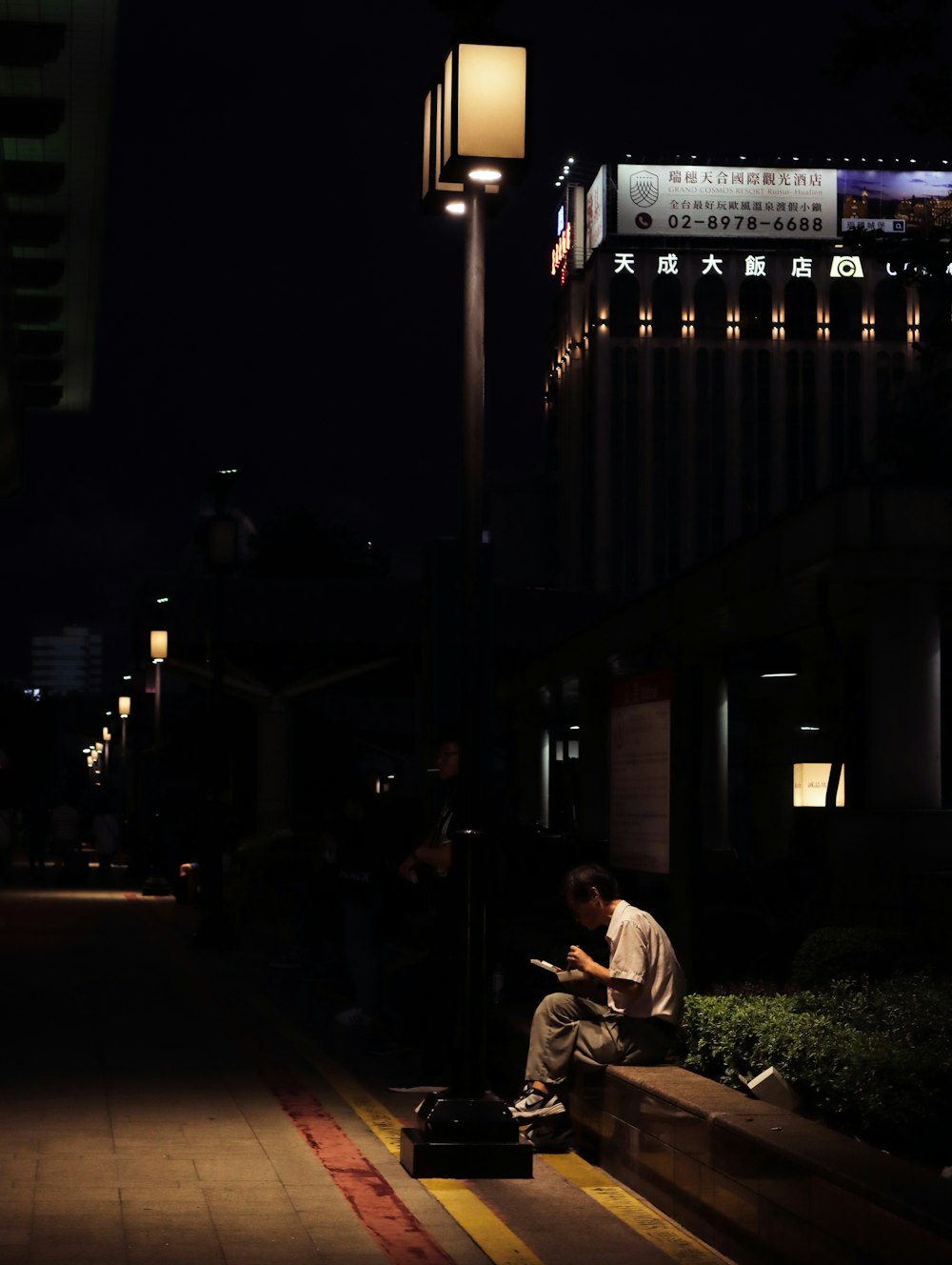 man in white dress shirt sitting on chair during night time