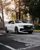 white mercedes benz coupe parked on the side of the road