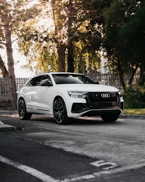 white mercedes benz coupe parked on the side of the road