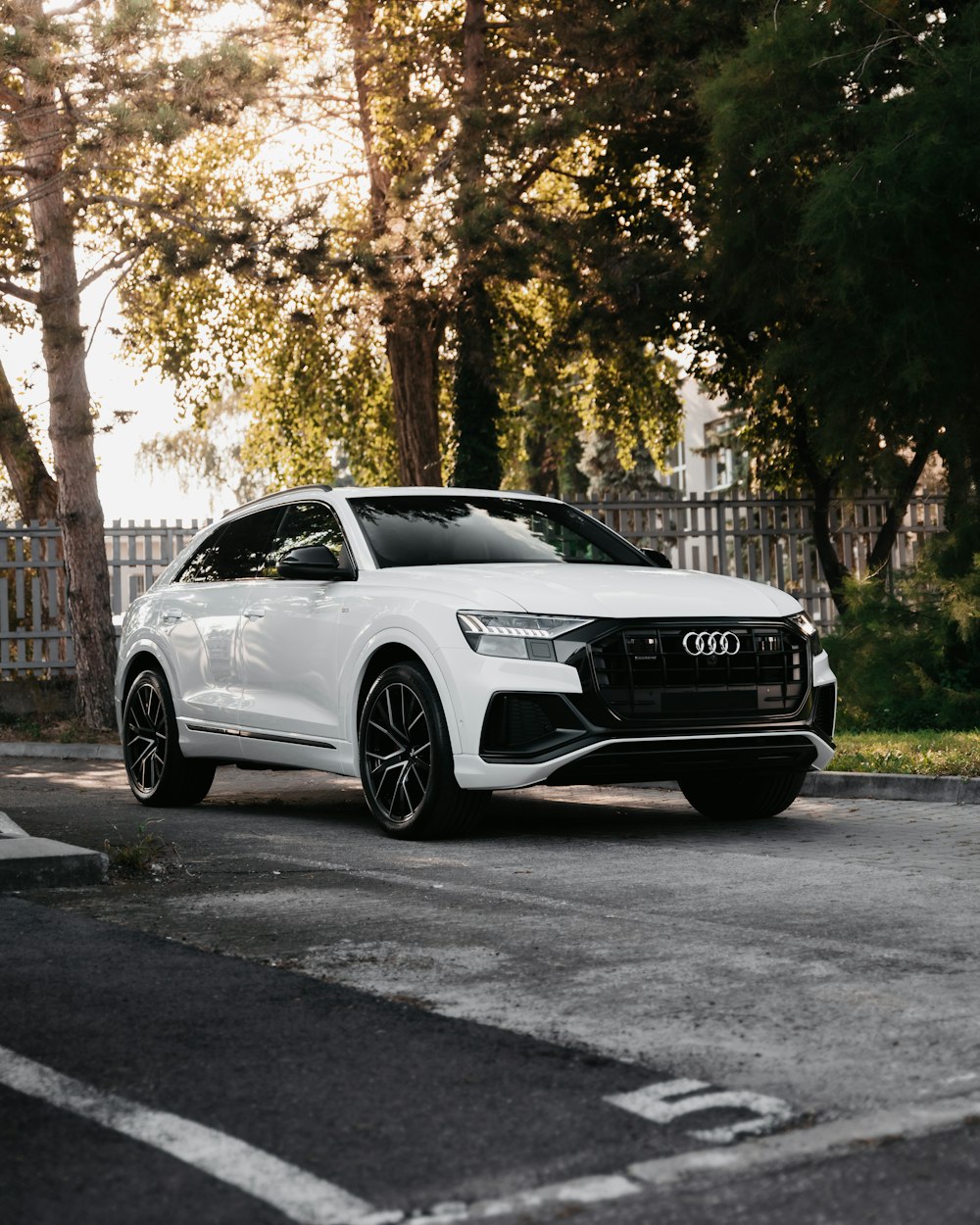 white mercedes benz coupe parked on the side of the road