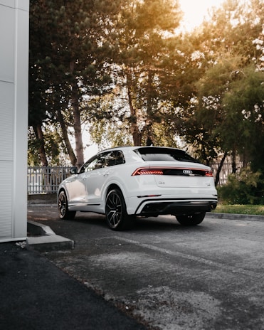 white porsche 911 parked near white building