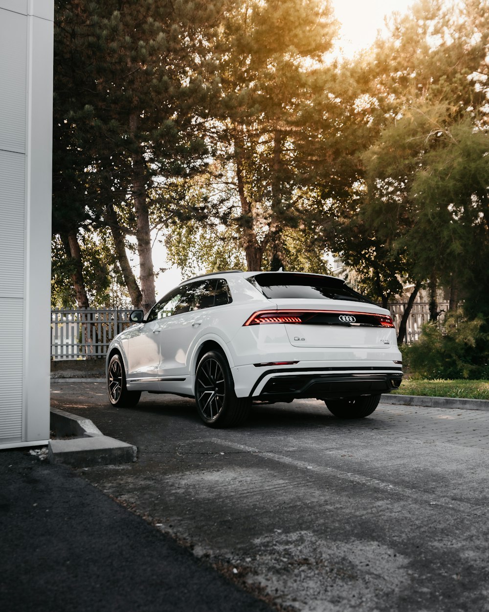 white porsche 911 parked near white building