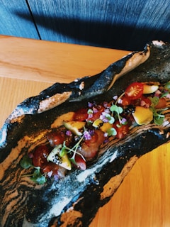A colorful plate of healthy food arranged beautifully on a table.