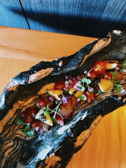 A beautifully plated signature dish with vibrant colors and fresh herbs.