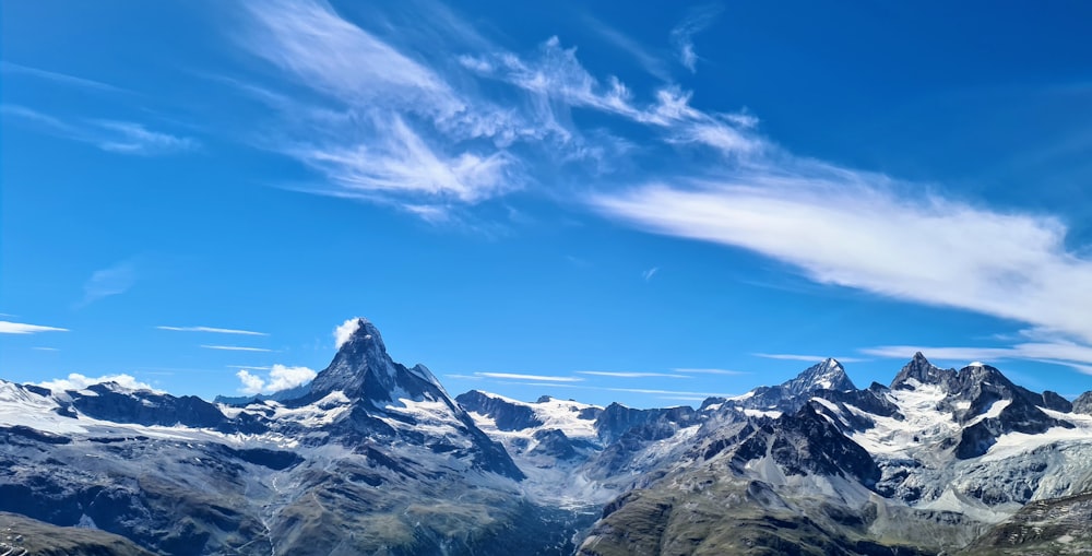 snow covered mountain under blue sky during daytime