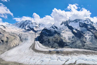 A crisp photograph of towering ice mountains piercing a bright blue sky.