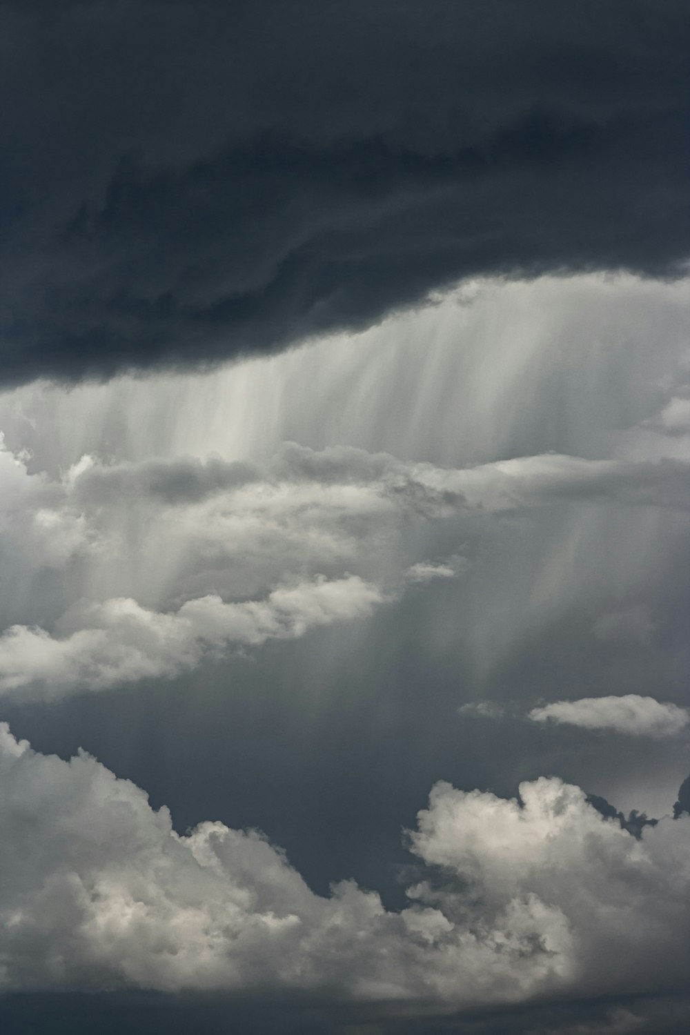 white clouds over mountain during daytime