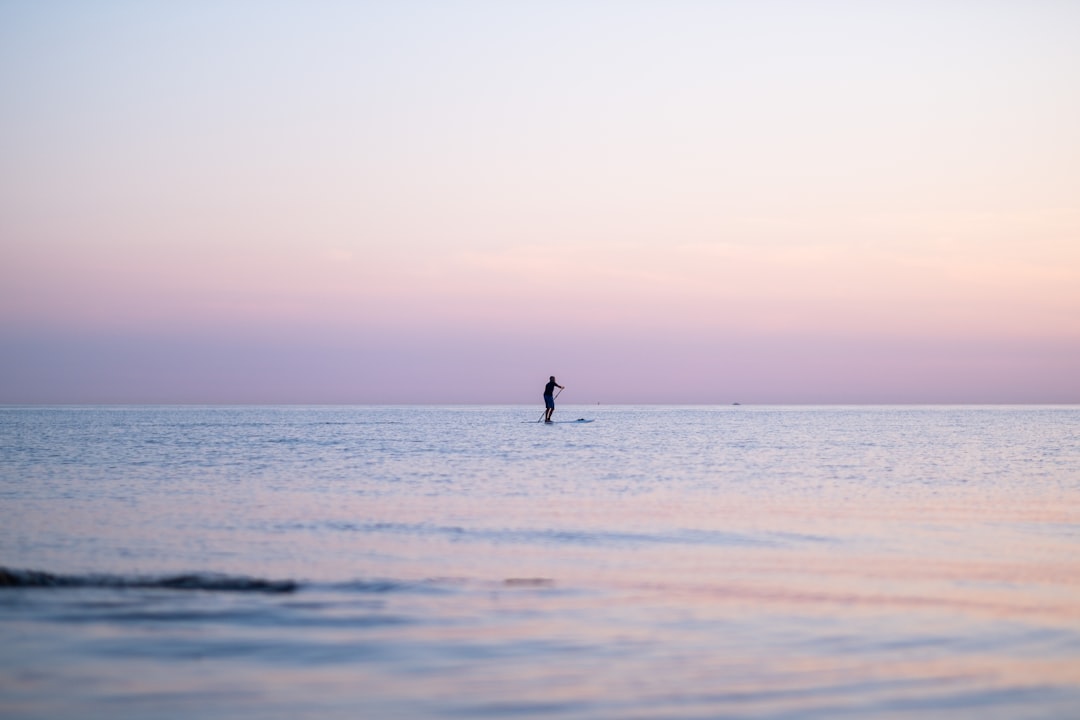 person walking on beach during daytime