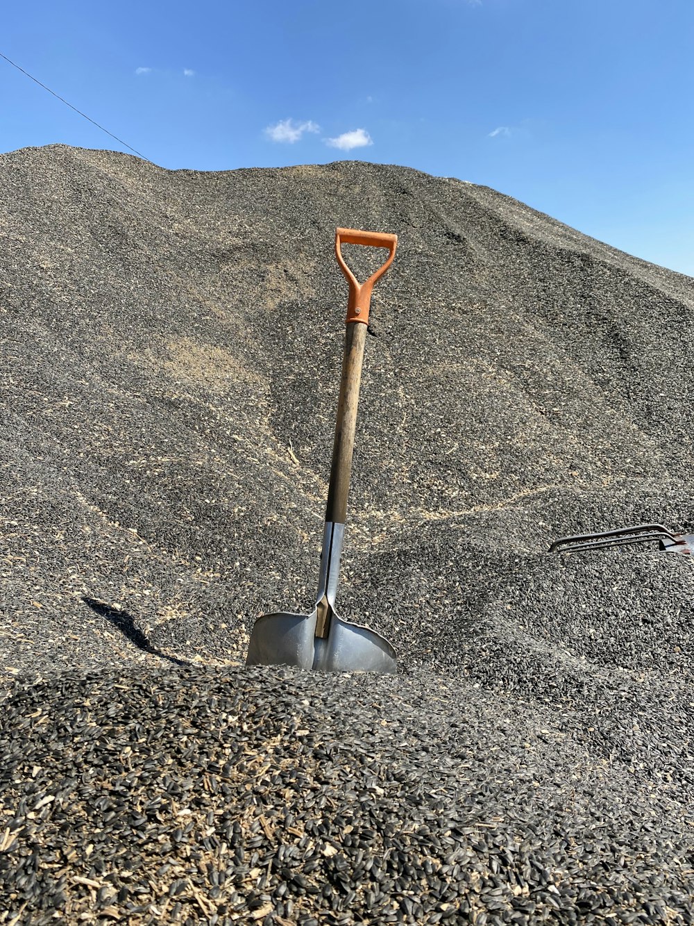 red and gray shovel on gray sand