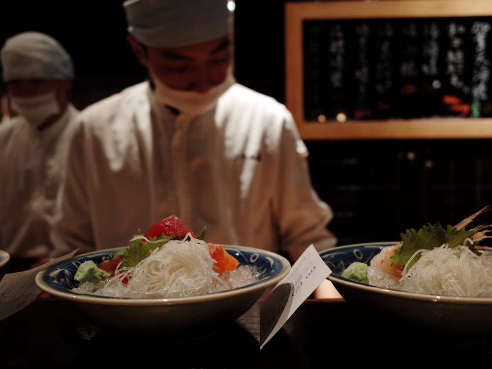 man in white thobe eating vegetable salad