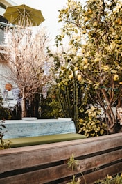 UV-resistant patio cushions in vibrant colors stacked neatly on a wooden bench