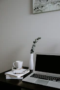 A minimalist workspace with legal books, a tablet displaying client acquisition data, and a gold-accented coffee cup.