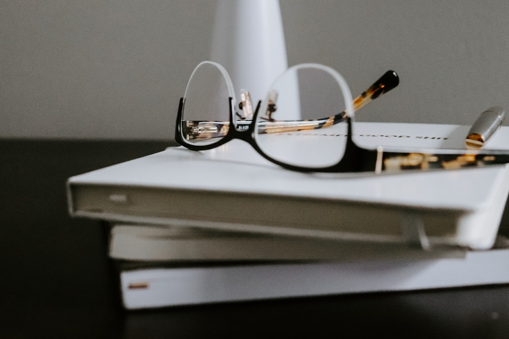 silver framed eyeglasses on white book page