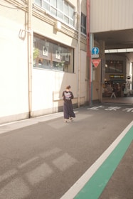 A serene street scene with a person wearing a donko t-shirt, the bronze diamond catching the sunlight subtly.
