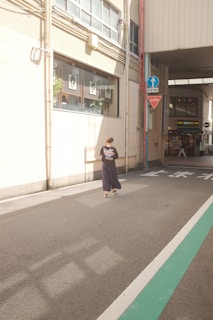 A serene street scene with a person wearing a donko t-shirt, the bronze diamond catching the sunlight subtly.