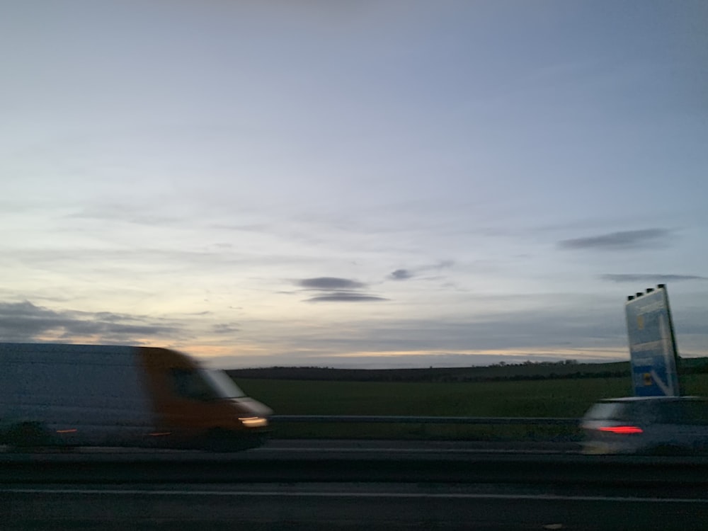 orange and white car on road during daytime