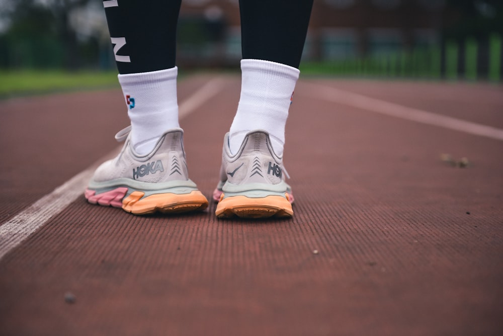 person in white nike shoes