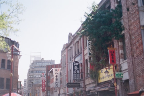 A vibrant neighborhood street in Pune with a mix of residential and commercial buildings.