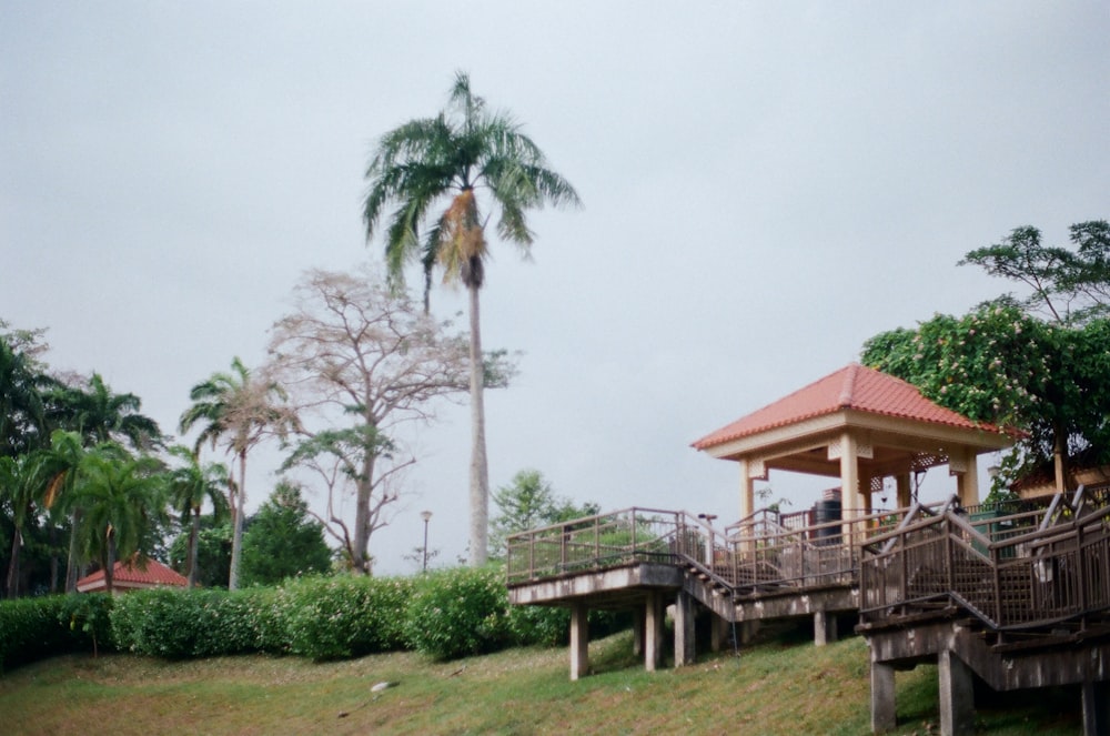 brown wooden house near green trees during daytime