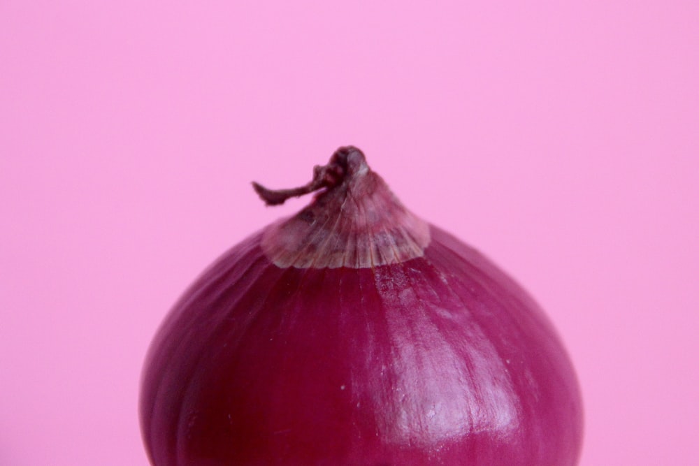red onion on pink surface