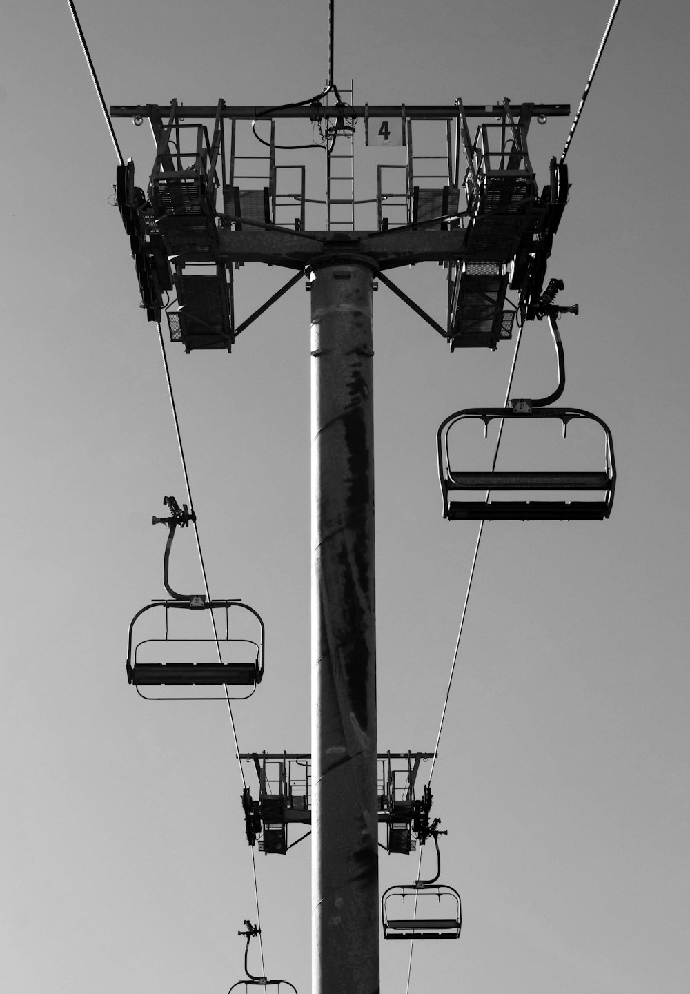 a black and white photo of a ski lift