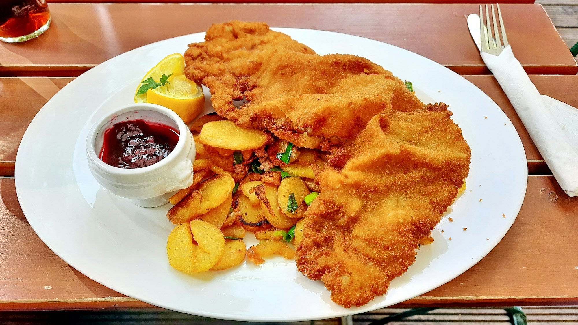 A famous Wiener Schnitzel made from veal escalope, always served with lemon, sometimes with berry sauce. Take care:Schnitzel Wiener Art is in most cases not the same. "Guten Appetit" (enjoy your meal).
| Picture made and Schnitzel eaten at restaurant Zollpackhof, Berlin.