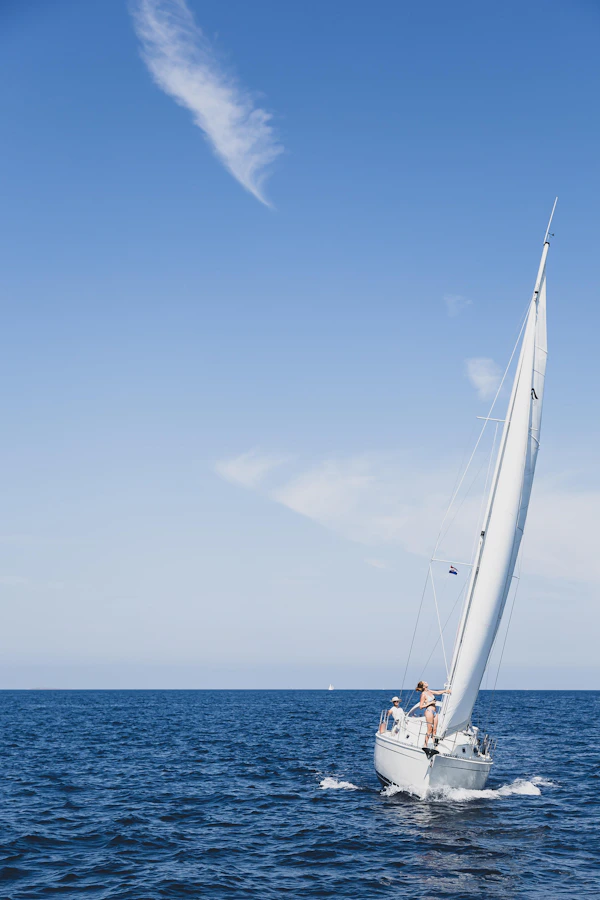 Yacht at anchor over clear tropical water