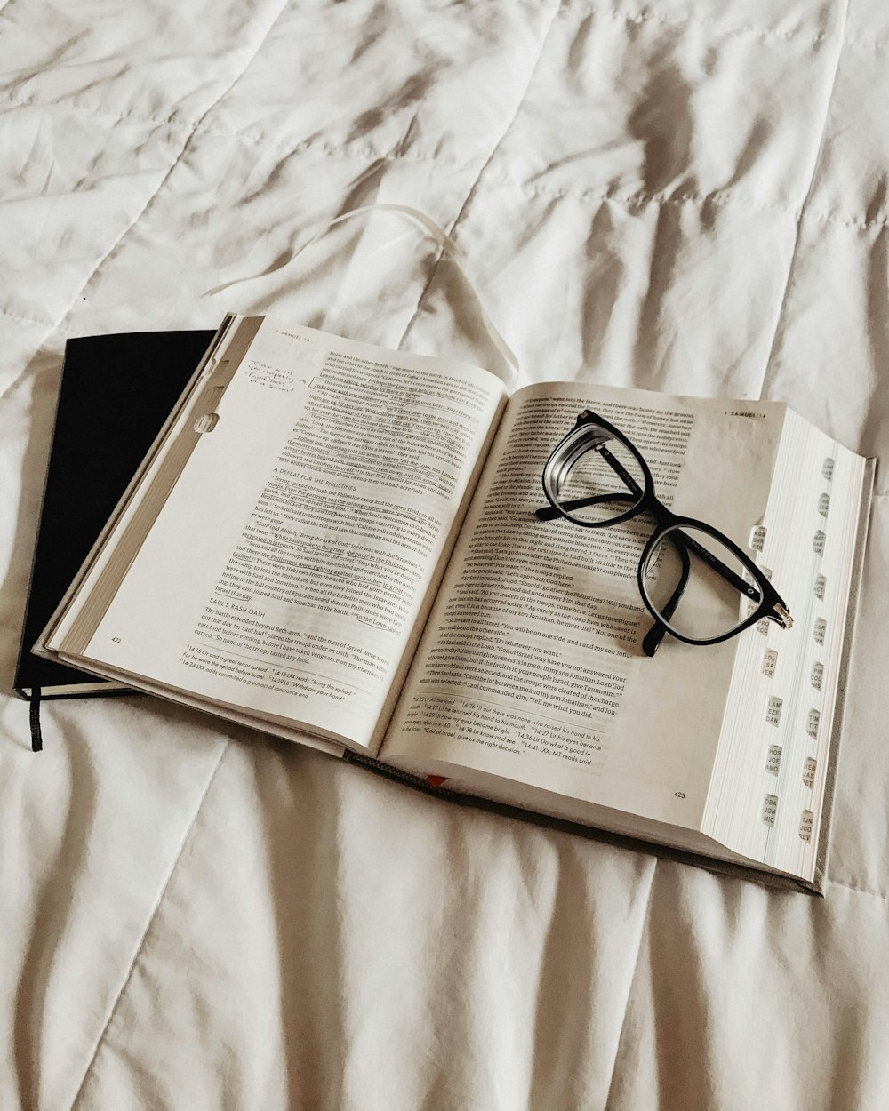 black framed eyeglasses on book page