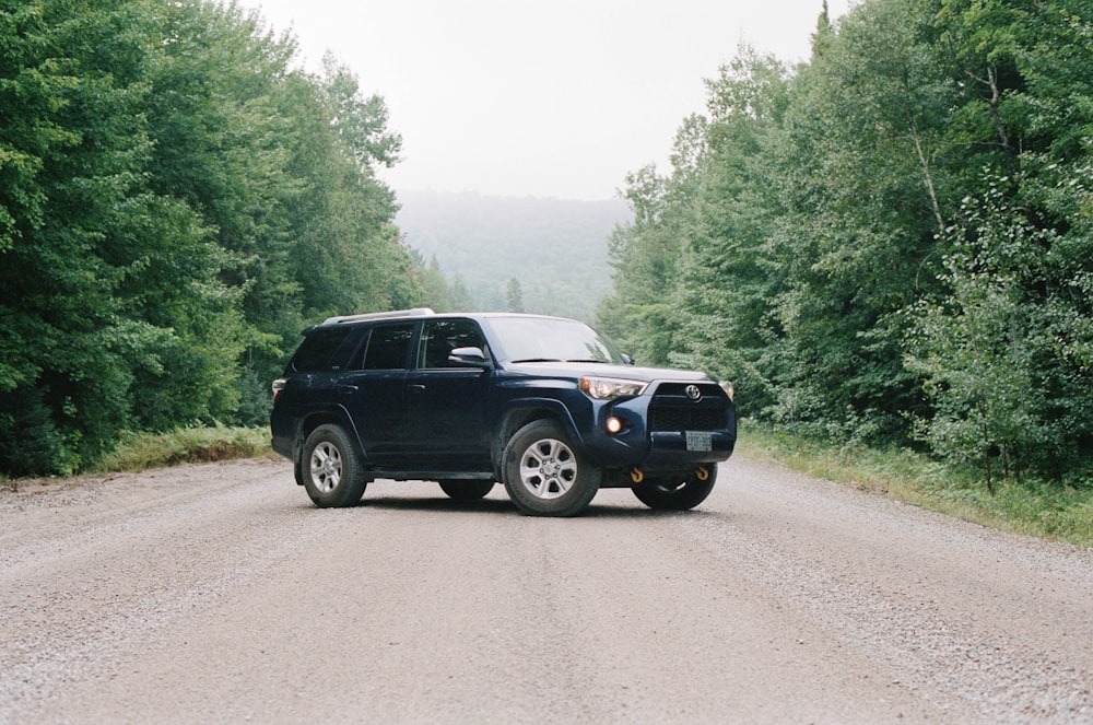 black suv on road during daytime