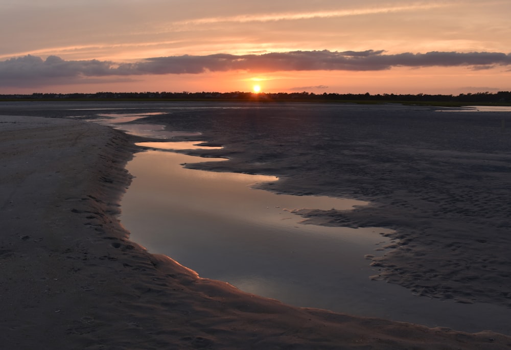 body of water during sunset