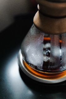 Clear glass bottle filled with dark cold brew coffee with condensation on the outside