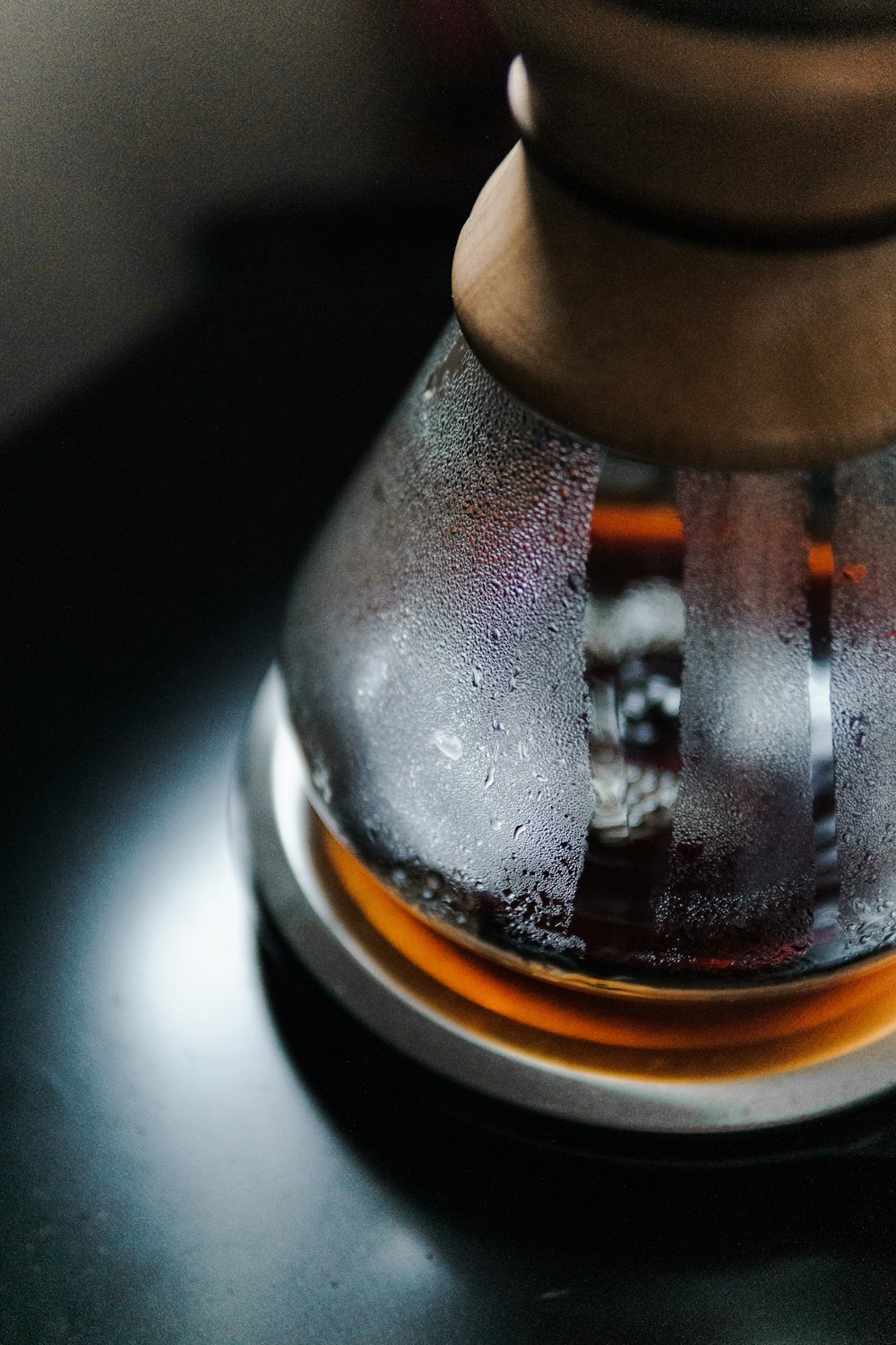 clear glass bottle with brown liquid