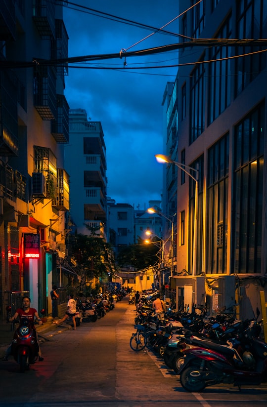people walking on street during night time in Sanya China
