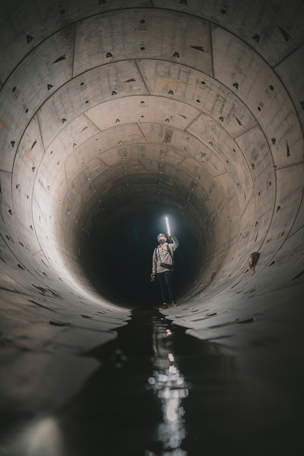 2 person walking on tunnel