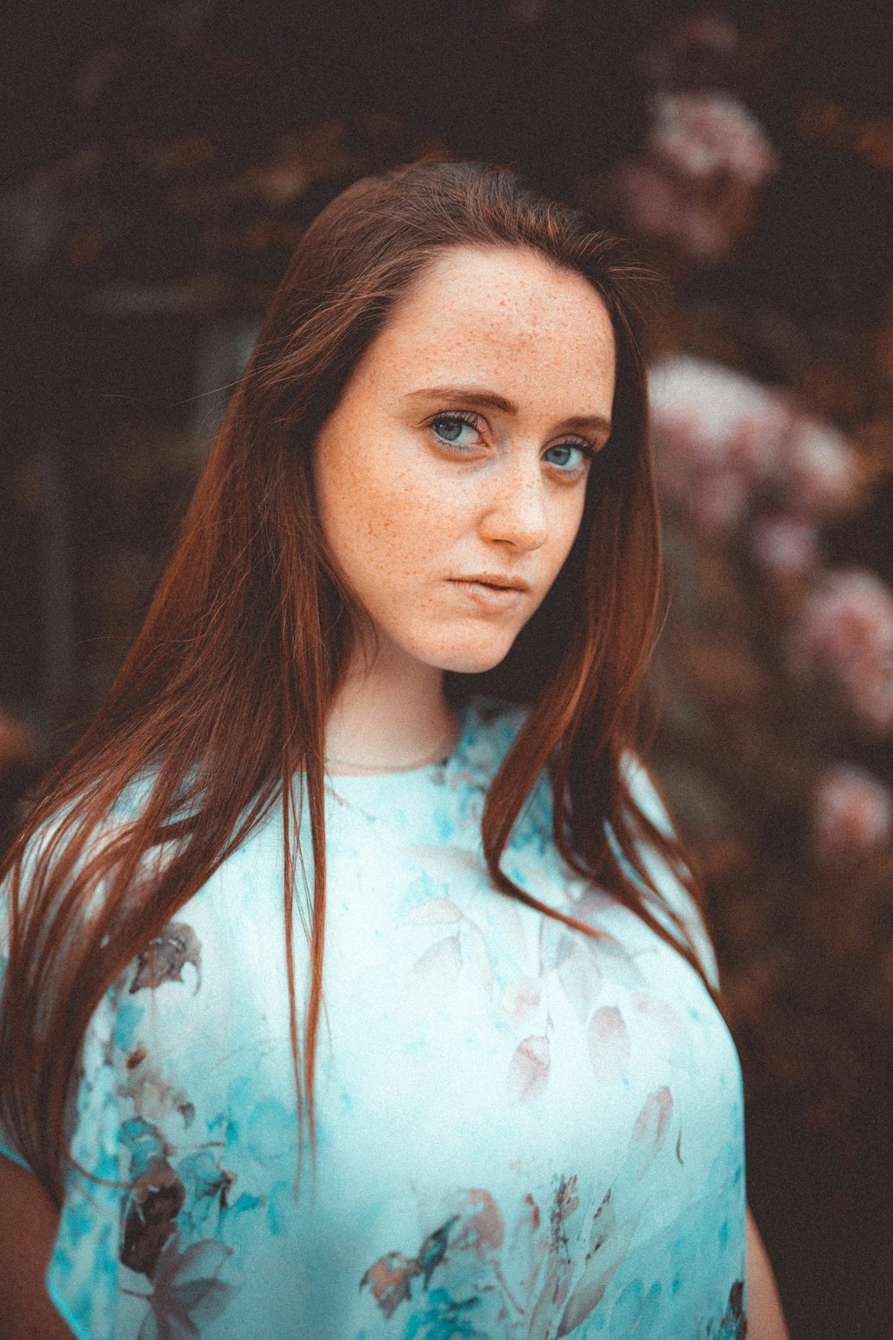 woman in white and blue floral shirt