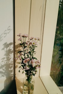 A serene morning scene with Serotoskin bottle beside a sunlit window and fresh flowers.