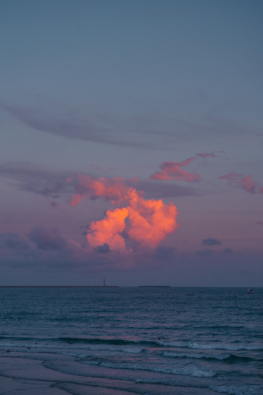 sea under white clouds during daytime