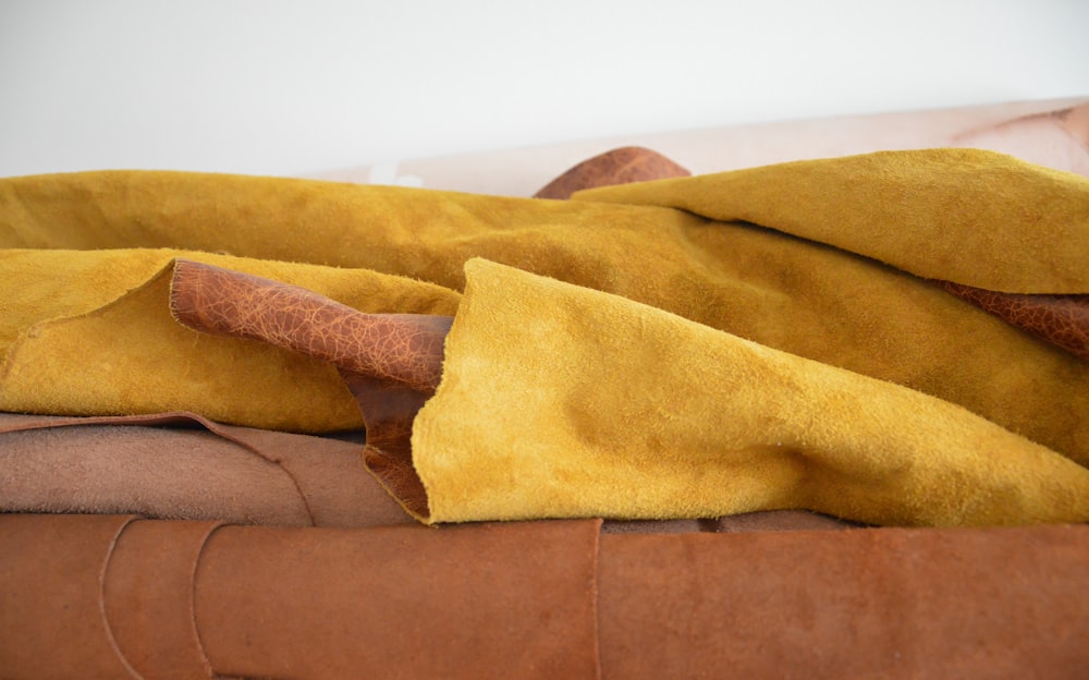 yellow textile on brown couch
