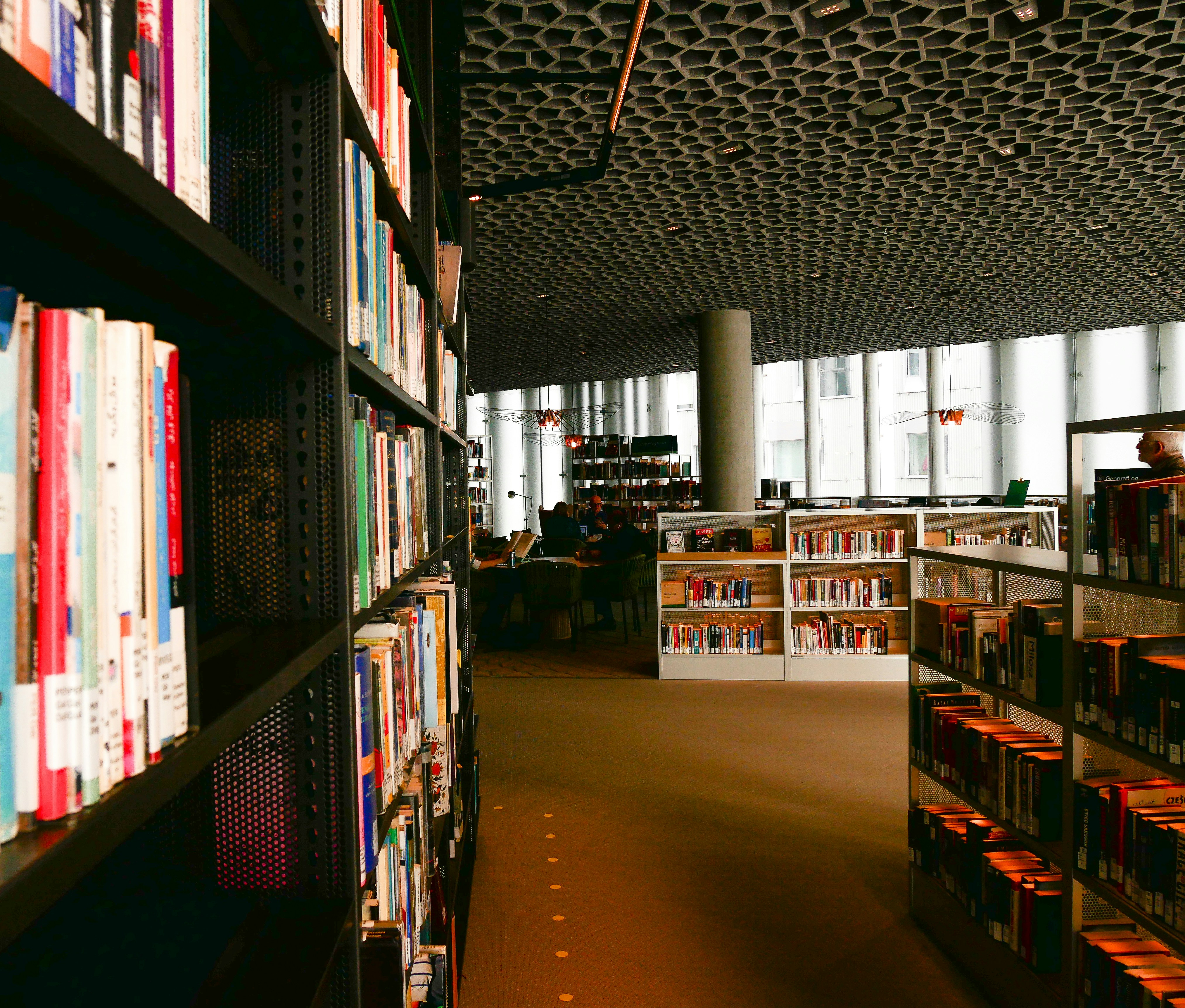 red and white labeled book on shelves
