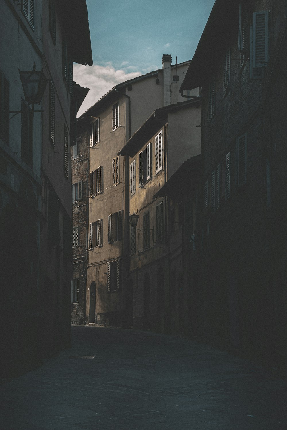 empty street in between of concrete buildings