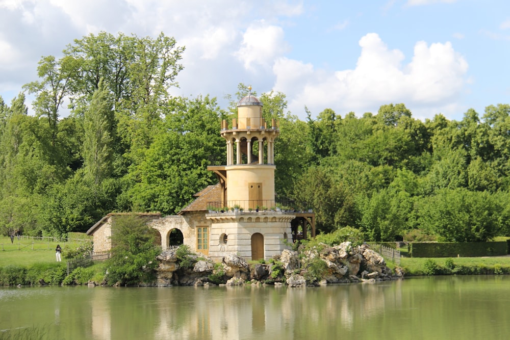 brown concrete building near green trees and river during daytime