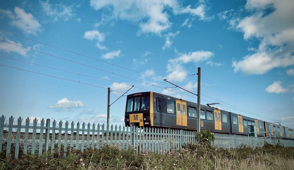 yellow and brown train on rail during daytime