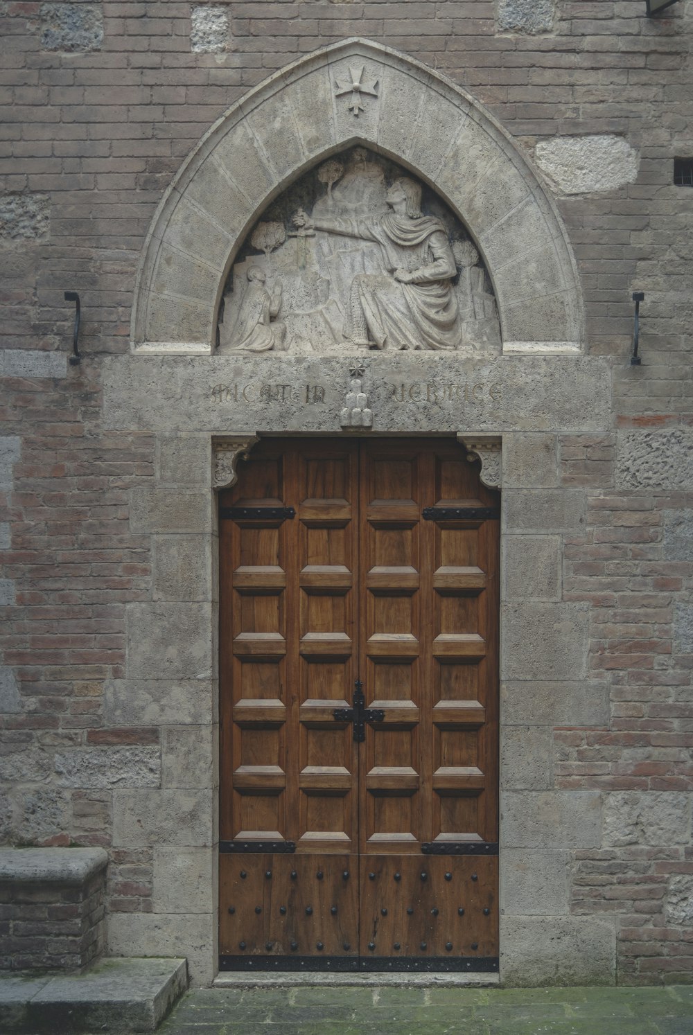 brown wooden door on gray concrete wall