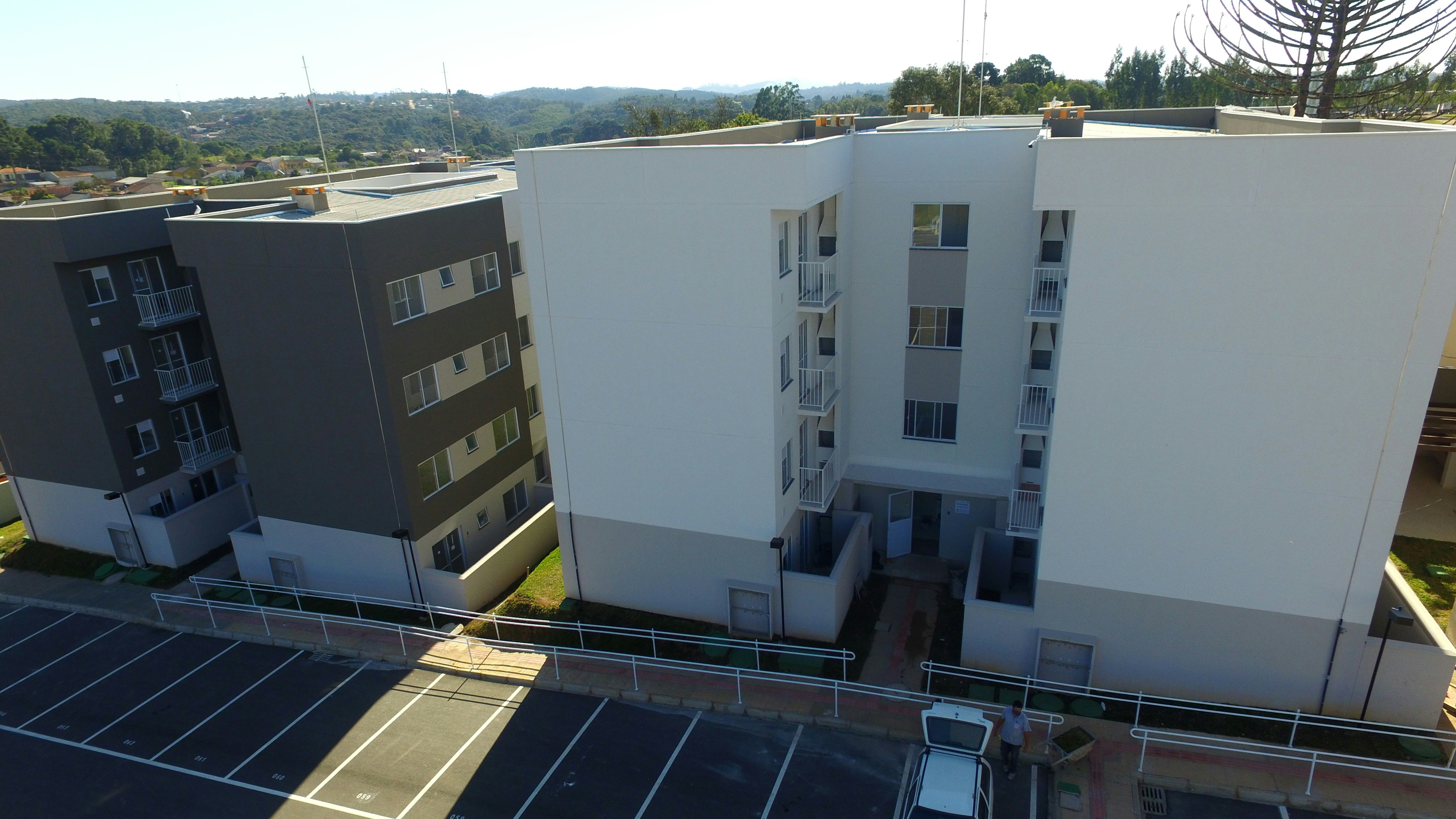 Modern apartment complex with balconies and parking